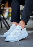 White sneakers with zippers worn by a person on a blurred background