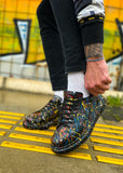 Person wearing colorful sneakers on a yellow and black striped surface