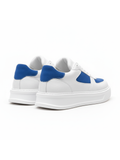 White sneakers with blue accents on a white background