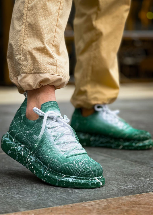 Man wearing Torino Green Peak White Mesh sneakers with green gradient and white splatter design.
