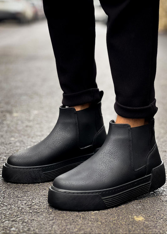 Avalon Onyx Chelsea boot in matte black by Apollo Moda, worn with cuffed trousers