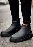 Avalon Onyx Chelsea boot in matte black by Apollo Moda, worn with cuffed trousers