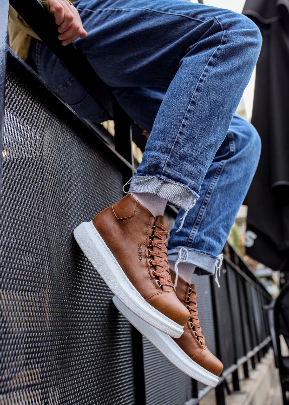 Men's Kelly Rustic Rendezvous brown high-top boot by Apollo Moda, worn on a staircase